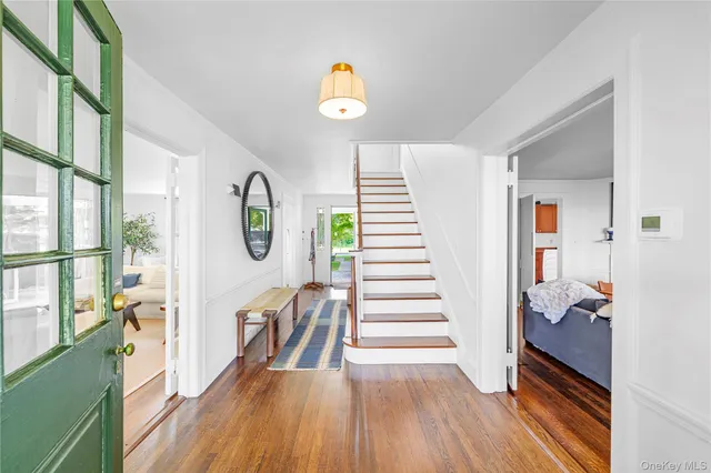 a living room with furniture fireplace and a large window