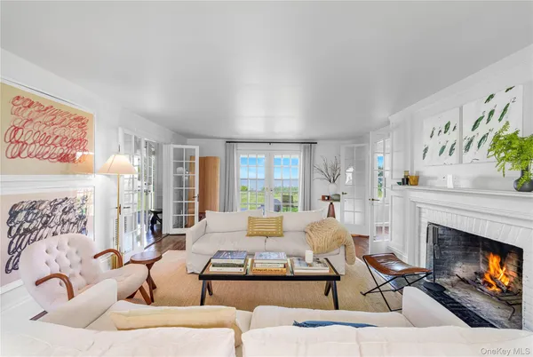 a living room with furniture a fireplace and a table