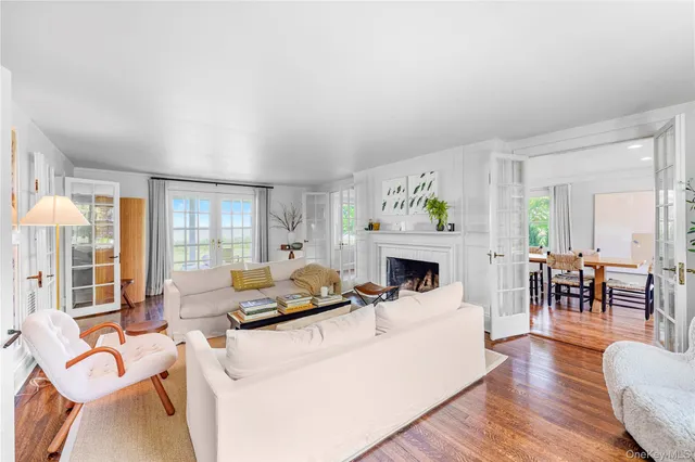 a living room with furniture fireplace and a table