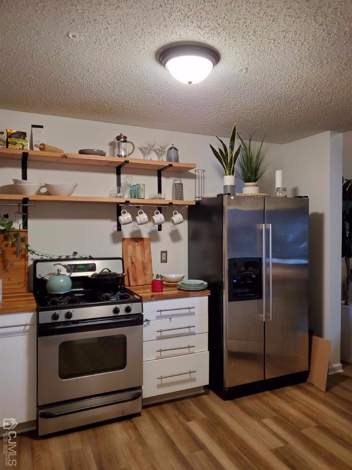 233 Edpas Road, Unit 233 New Brunswick, NJ 08901 - Photo 1 of 21 a kitchen with stainless steel appliances a stove and a refrigerator