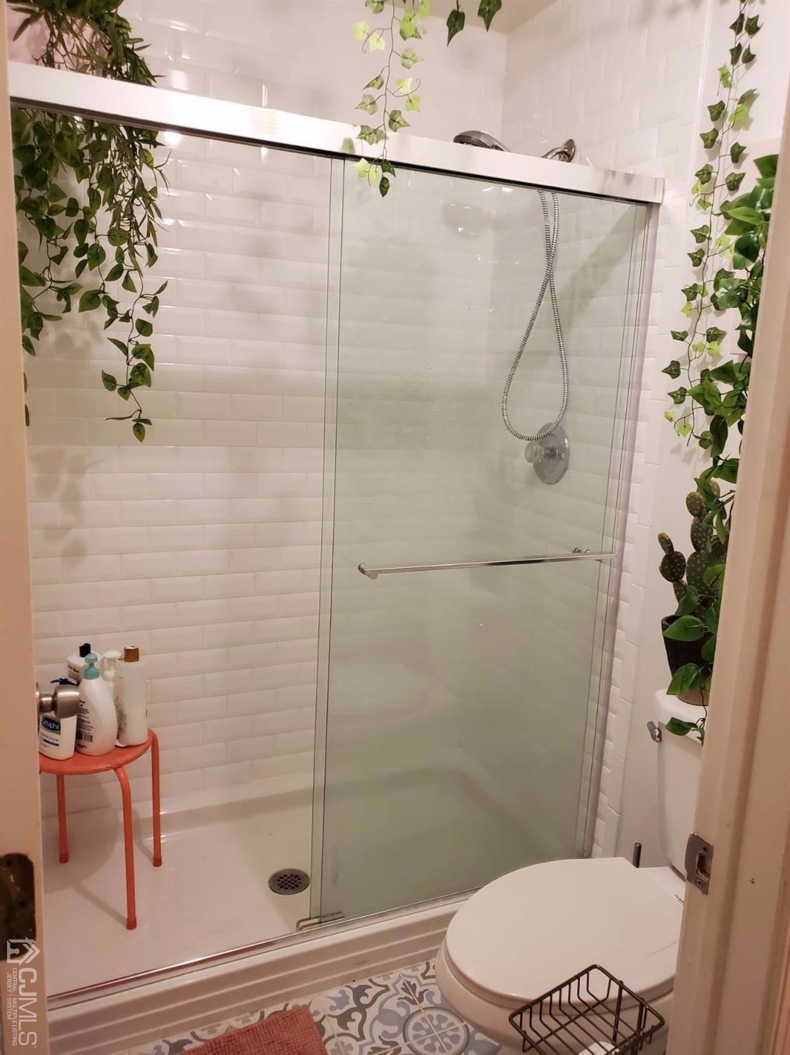 233 Edpas Road, Unit 233 New Brunswick, NJ 08901 - Photo 12 of 21 a bathroom with a shower and a toilet