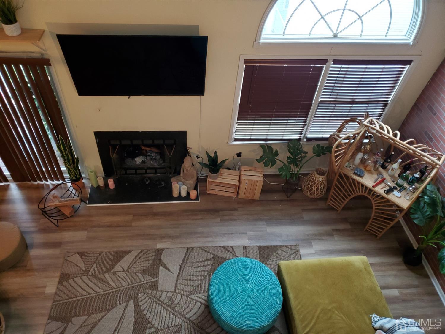 233 Edpas Road, Unit 233 New Brunswick, NJ 08901 - Photo 7 of 21 a living room with furniture and a fireplace