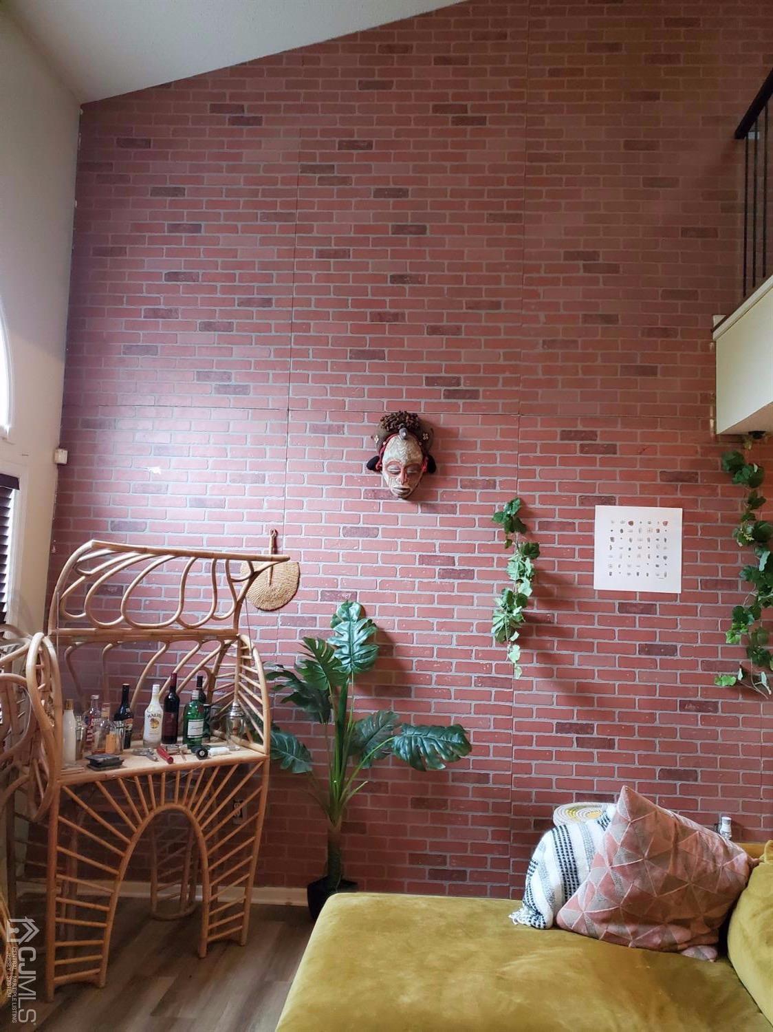 233 Edpas Road, Unit 233 New Brunswick, NJ 08901 - Photo 8 of 21 a bed sitting in a bedroom next to a brick wall