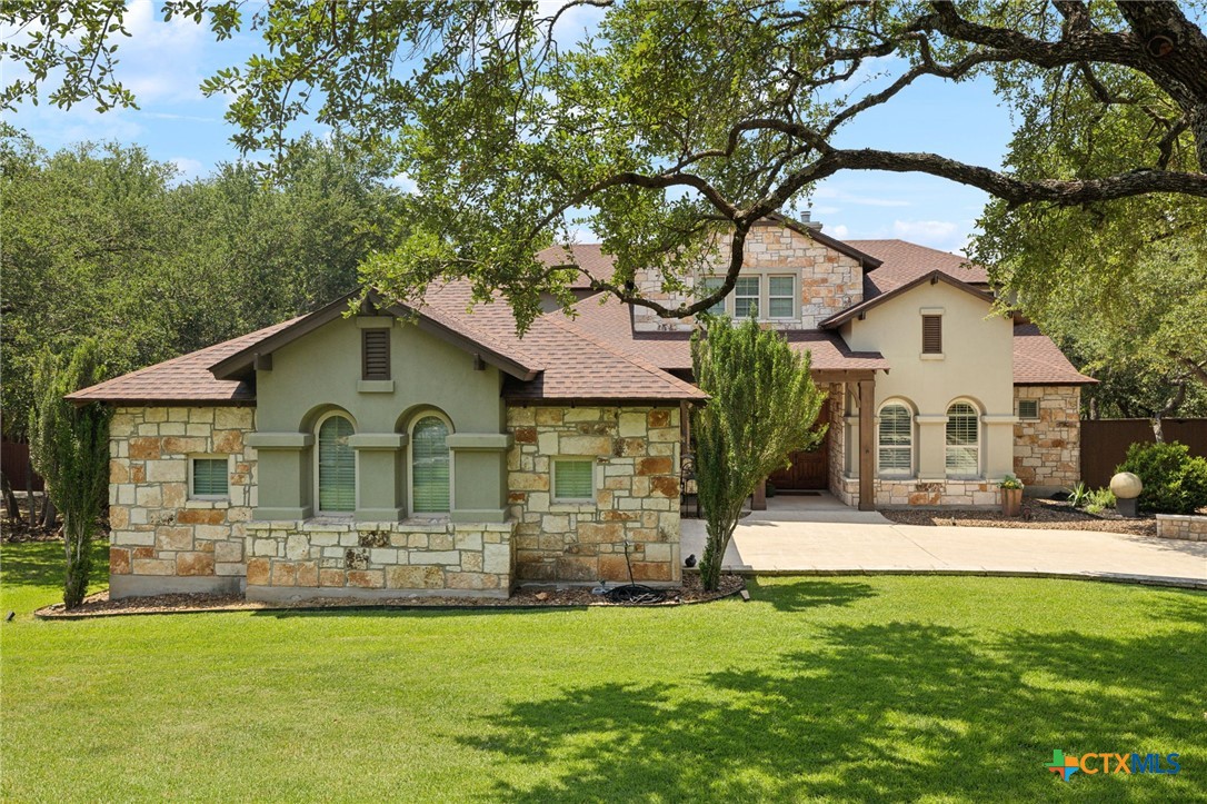 a front view of a house with yard and green space