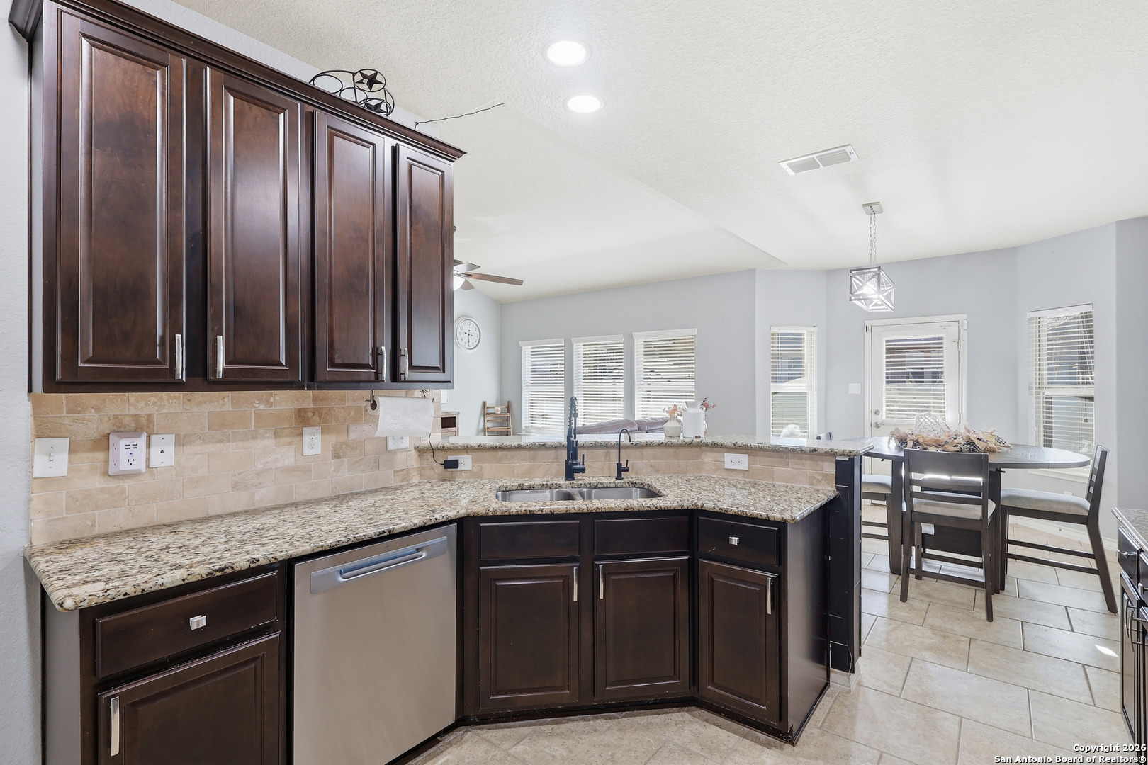 345 Morgan Run Cibolo, TX 78108 - Photo 6 of 22 a kitchen with granite countertop sink table and chairs