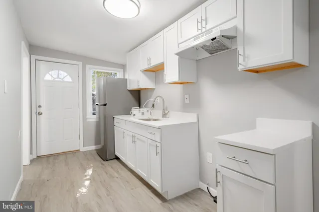 a utility room with cabinets washer and dryer