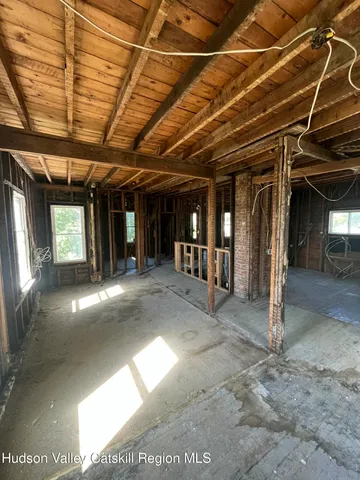 a view of a hallway with wooden walls