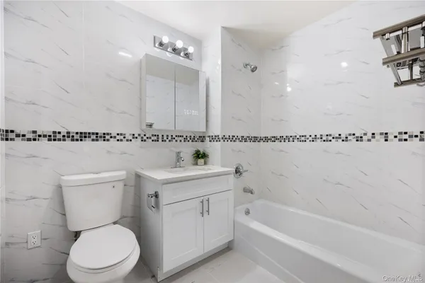 a bathroom with a sink a toilet and a bathtub