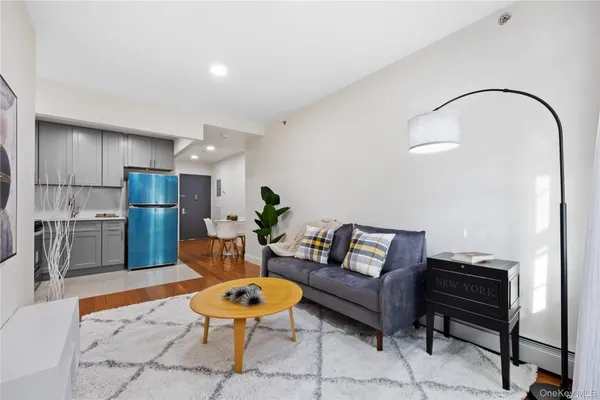a living room with furniture and kitchen view