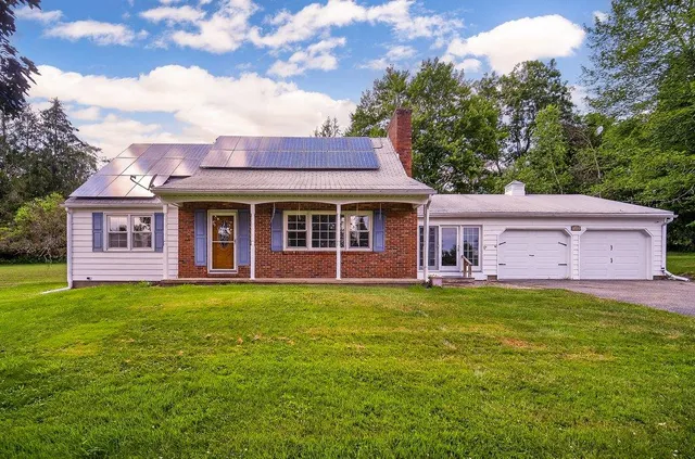 a front view of a house with a garden