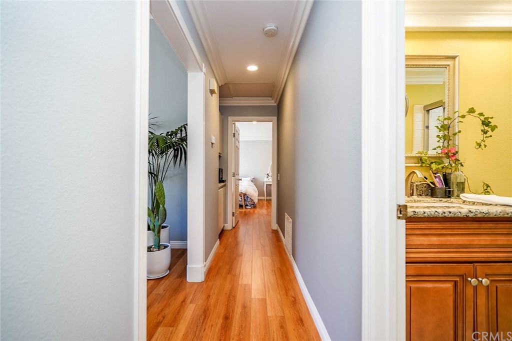17 Filare Irvine, CA 92620 - Photo 13 of 46 a view of a hallway with wooden floor and a potted plant