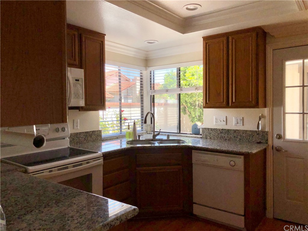17 Filare Irvine, CA 92620 - Photo 22 of 46 a kitchen with a sink stove and cabinets