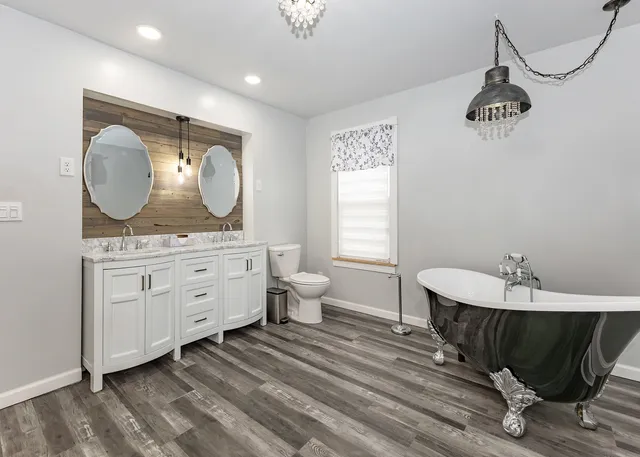 a spacious bathroom with a granite countertop sink and a mirror