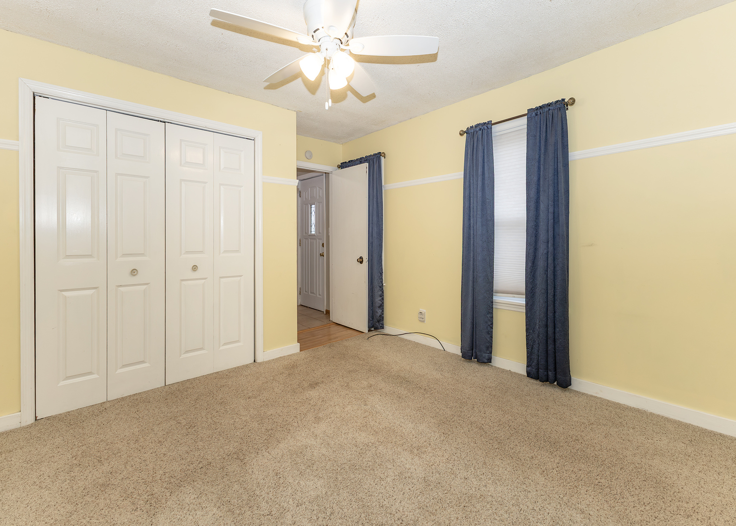 227 East 2nd Street Mineral, IL 61344 - Photo 19 of 28 an empty room with closet and a ceiling fan