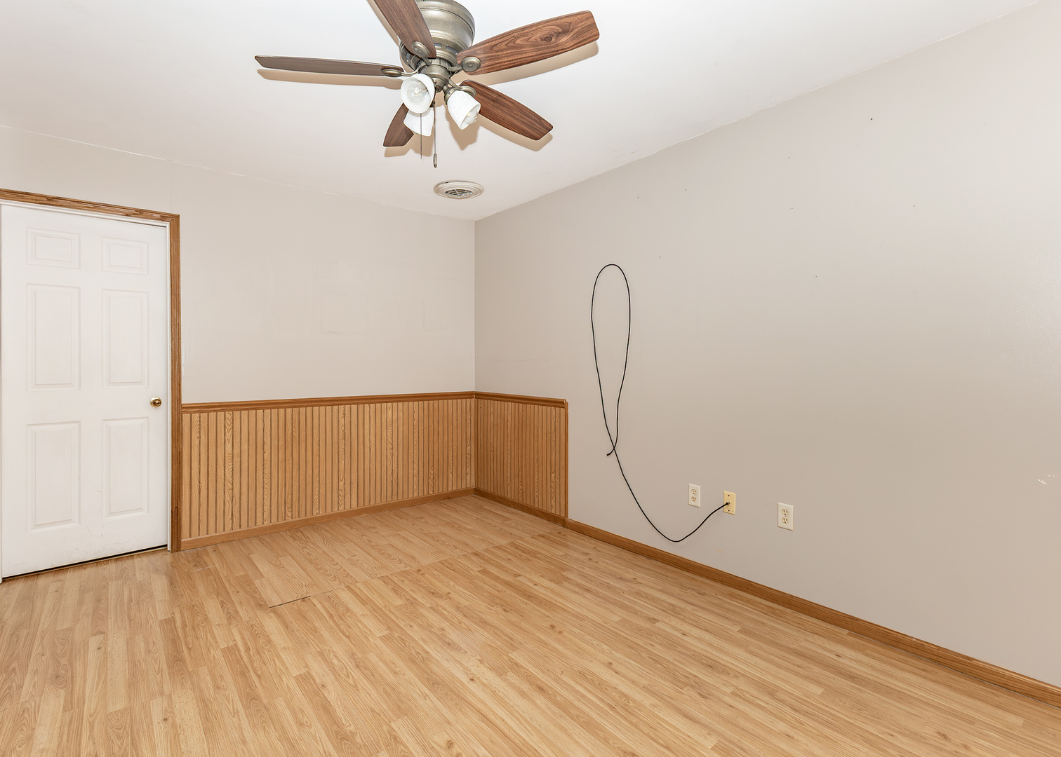 227 East 2nd Street Mineral, IL 61344 - Photo 22 of 28 an empty room with a ceiling fan and wooden floor