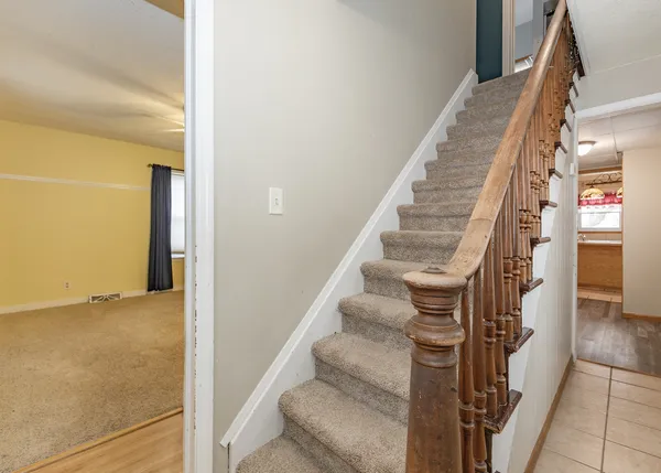a view of staircase with white walls