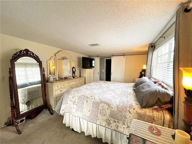 a bedroom with a bed and a mirror