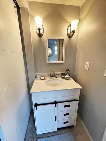 a bathroom with a sink a vanity and a mirror