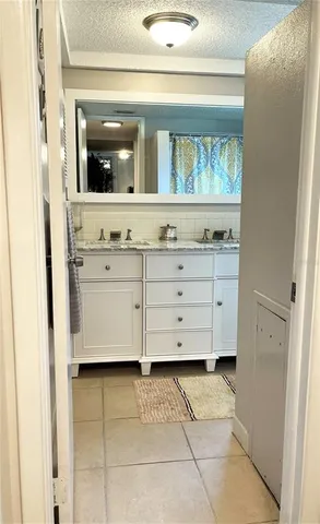 a bathroom with a bathtub sink and mirror