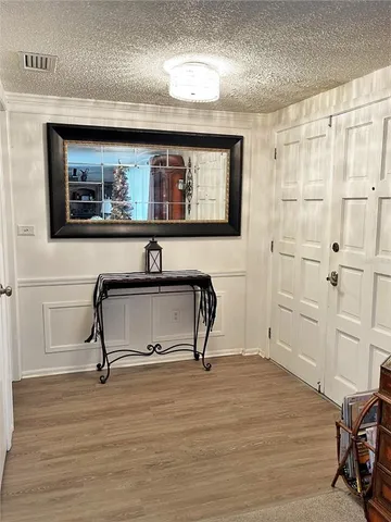 a view of a livingroom with wooden floor and furniture