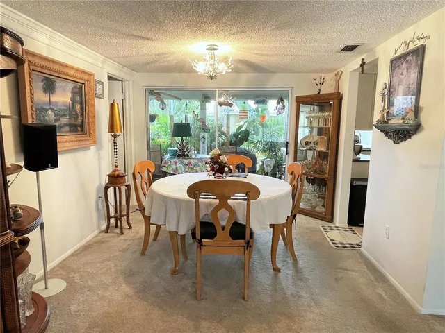 a dining room with furniture a chandelier and window