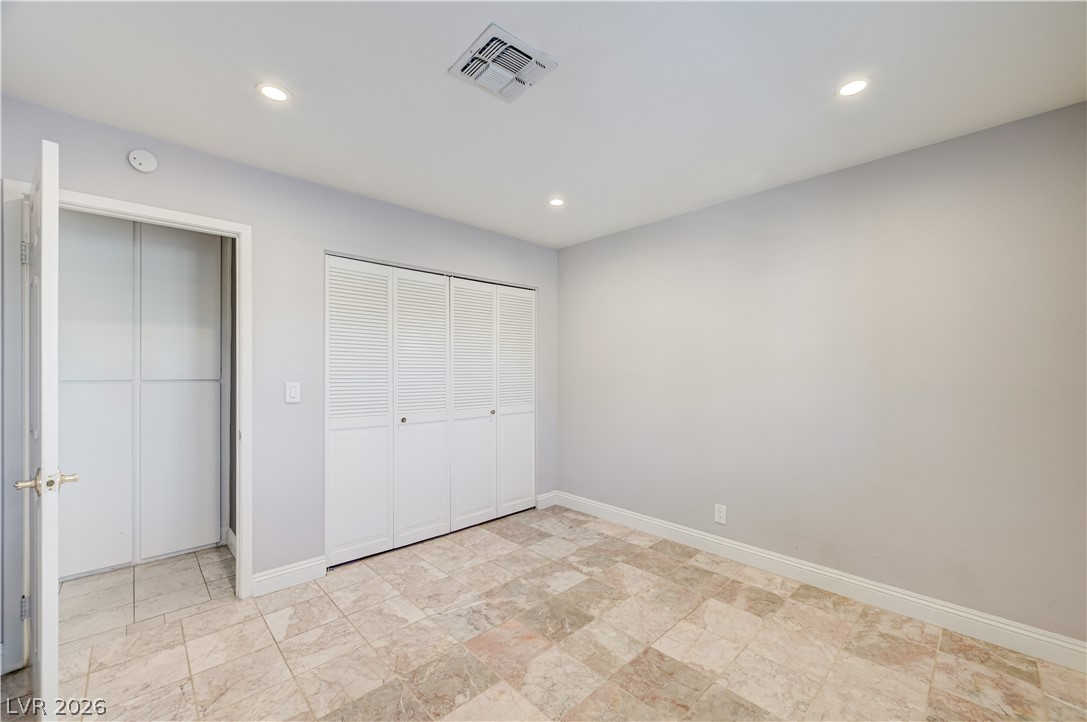 6635 Costa Brava Road Las Vegas, NV 89146 - Photo 47 of 59 Recessed lighting illuminates this versatile room featuring durable tiled flooring and louvered closet doors.