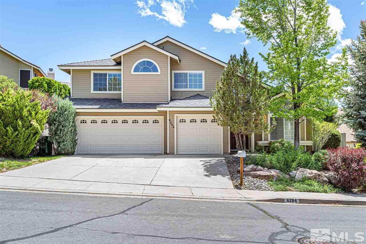 6284 Sunrise Meadows Loop Reno, NV 89519 - Photo 1 of 18 a front view of a house with a garden and trees