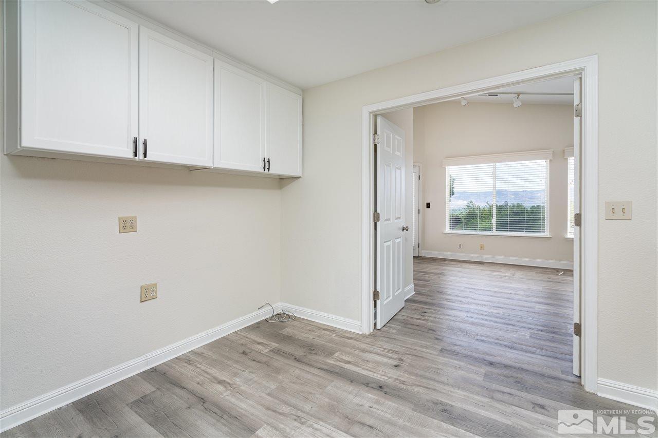 6284 Sunrise Meadows Loop Reno, NV 89519 - Photo 12 of 18 a view of an empty room with wooden floor and a window
