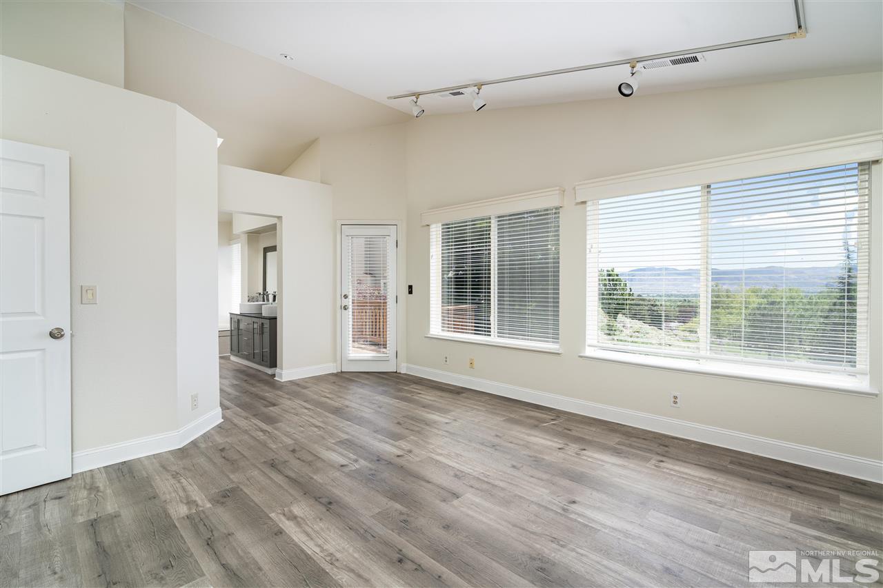 6284 Sunrise Meadows Loop Reno, NV 89519 - Photo 14 of 18 a view of an empty room with a window and wooden floor