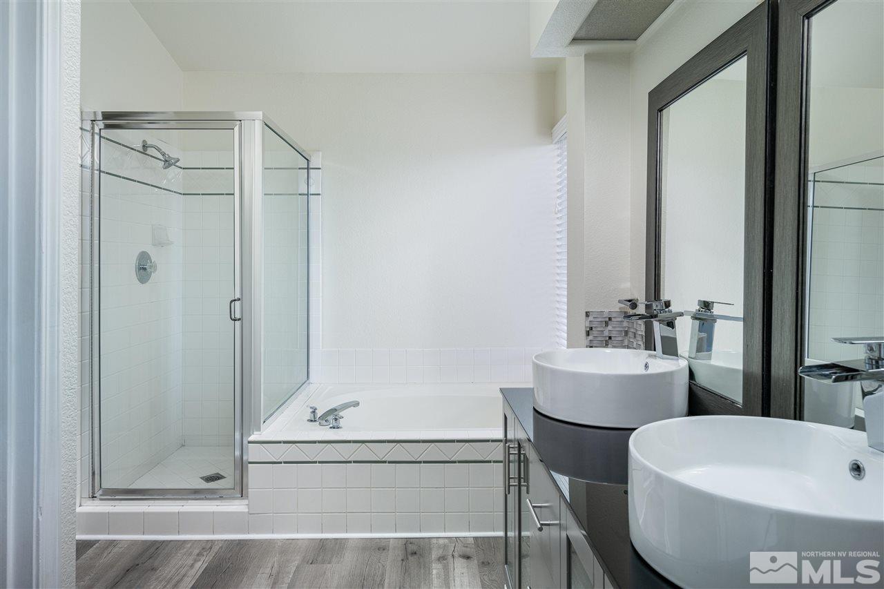 6284 Sunrise Meadows Loop Reno, NV 89519 - Photo 15 of 18 a bathroom with a sink and mirror with bathtub