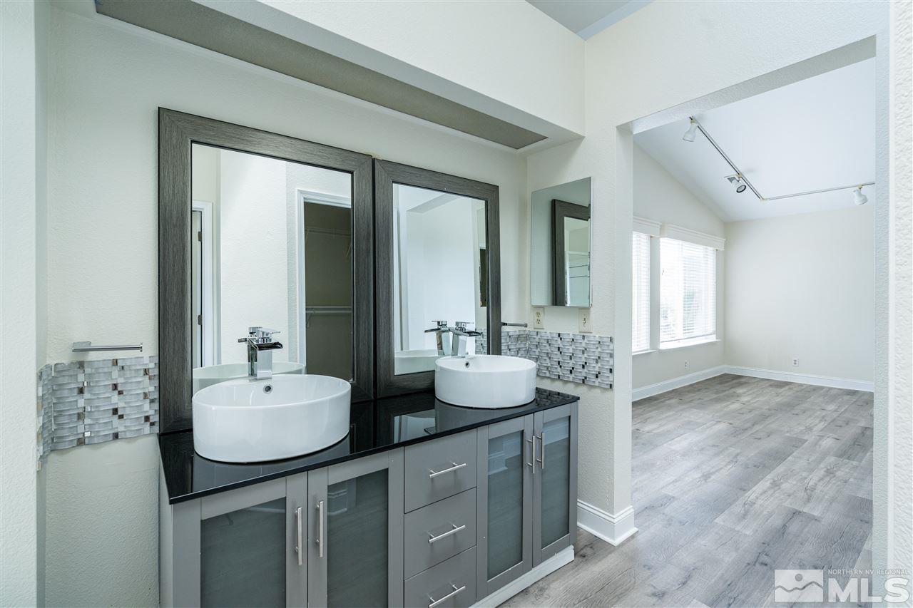 6284 Sunrise Meadows Loop Reno, NV 89519 - Photo 16 of 18 a bathroom with a double vanity sink and mirror