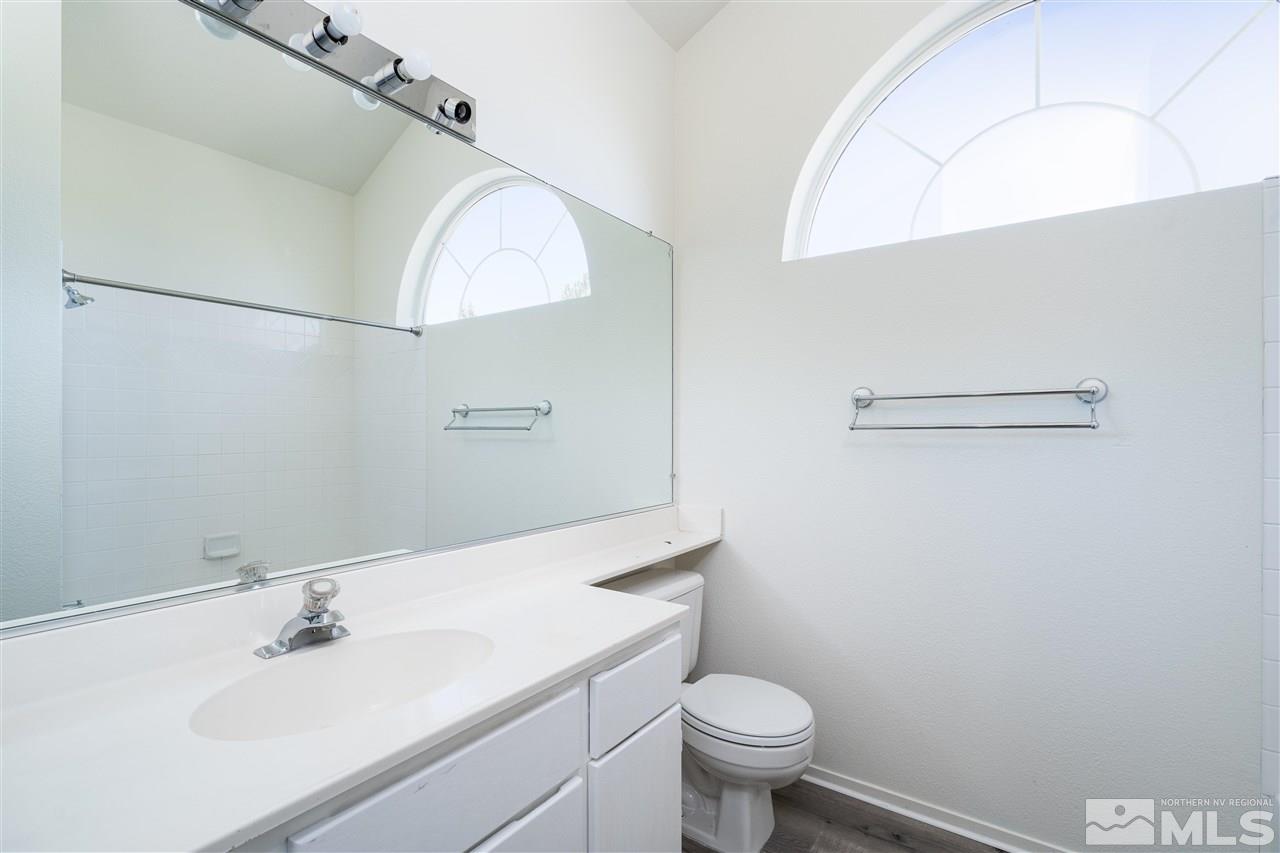 6284 Sunrise Meadows Loop Reno, NV 89519 - Photo 18 of 18 a bathroom with a sink toilet and a mirror