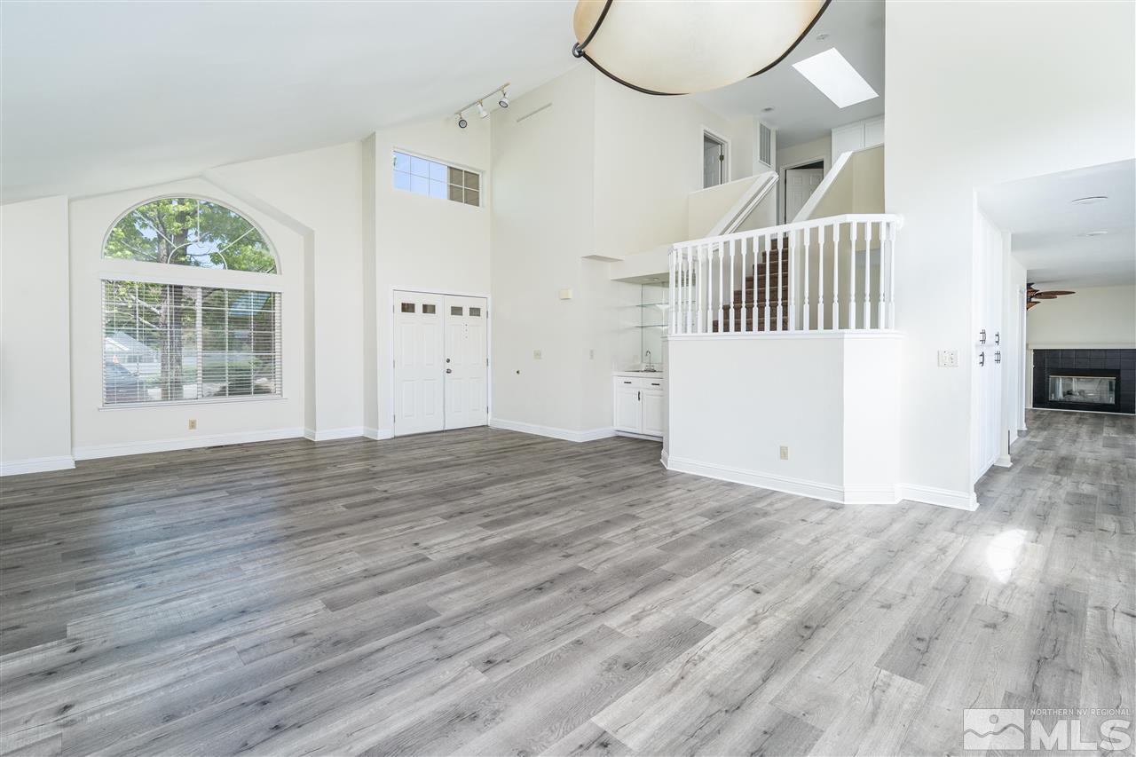 6284 Sunrise Meadows Loop Reno, NV 89519 - Photo 7 of 18 an empty room with wooden floor and windows