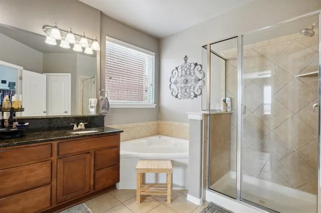 a bathroom with a sink a large mirror and a shower