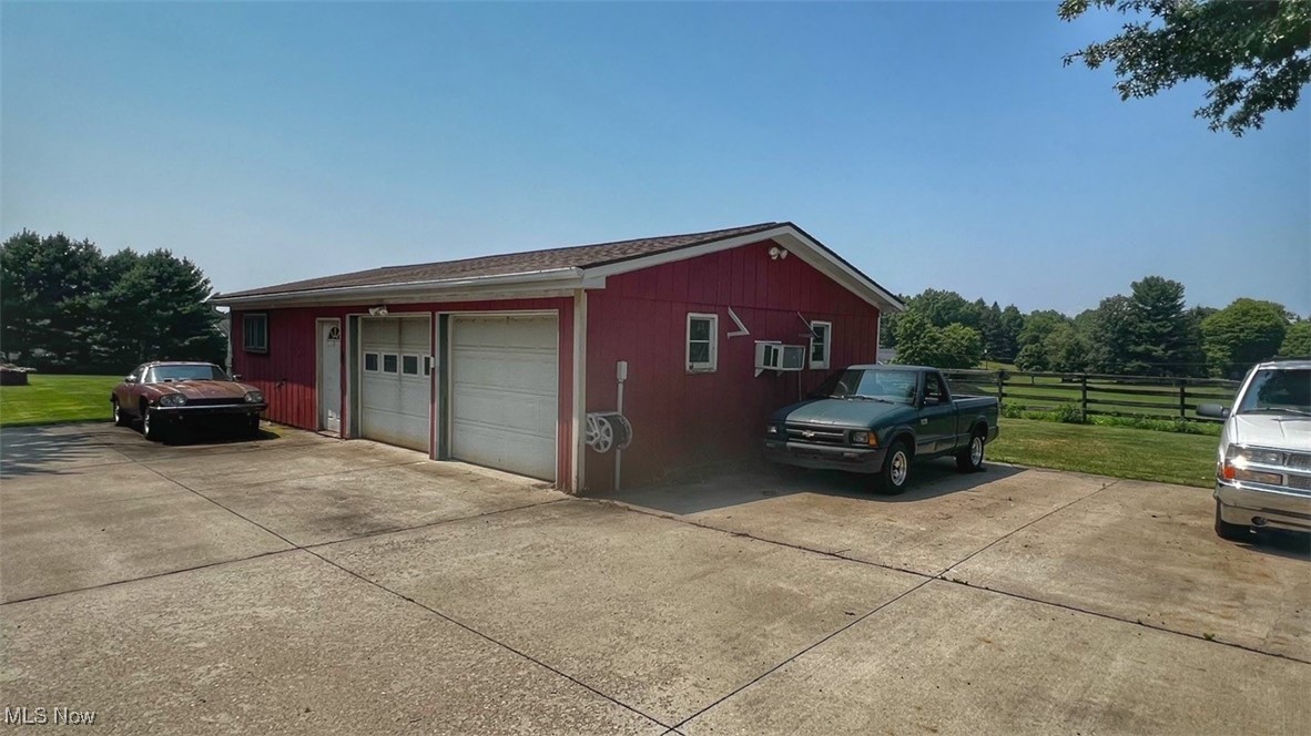 3956 Tallmadge Road Rootstown, OH 44272 - Photo 5 of 26 Garage featuring a lawn