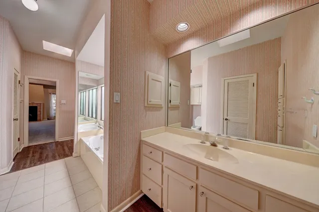 a en suite bathroom with a sink double vanity and a mirror