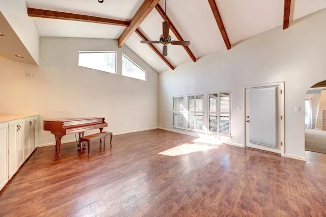 a view of a livingroom with furniture wooden floor and a window