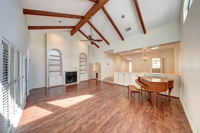 a livingroom with furniture a fireplace and wooden floor