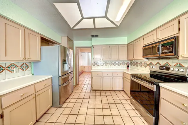 a kitchen with a stove a sink and a refrigerator