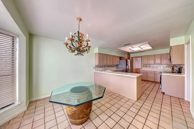a kitchen with a sink cabinets and window