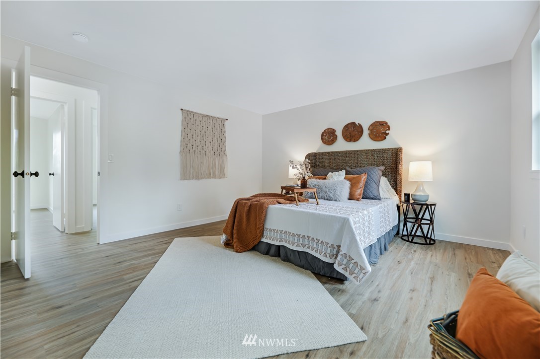 2807 Mill Avenue South Renton, WA 98055 - Photo 19 of 34 a bedroom with a bed and wooden floor