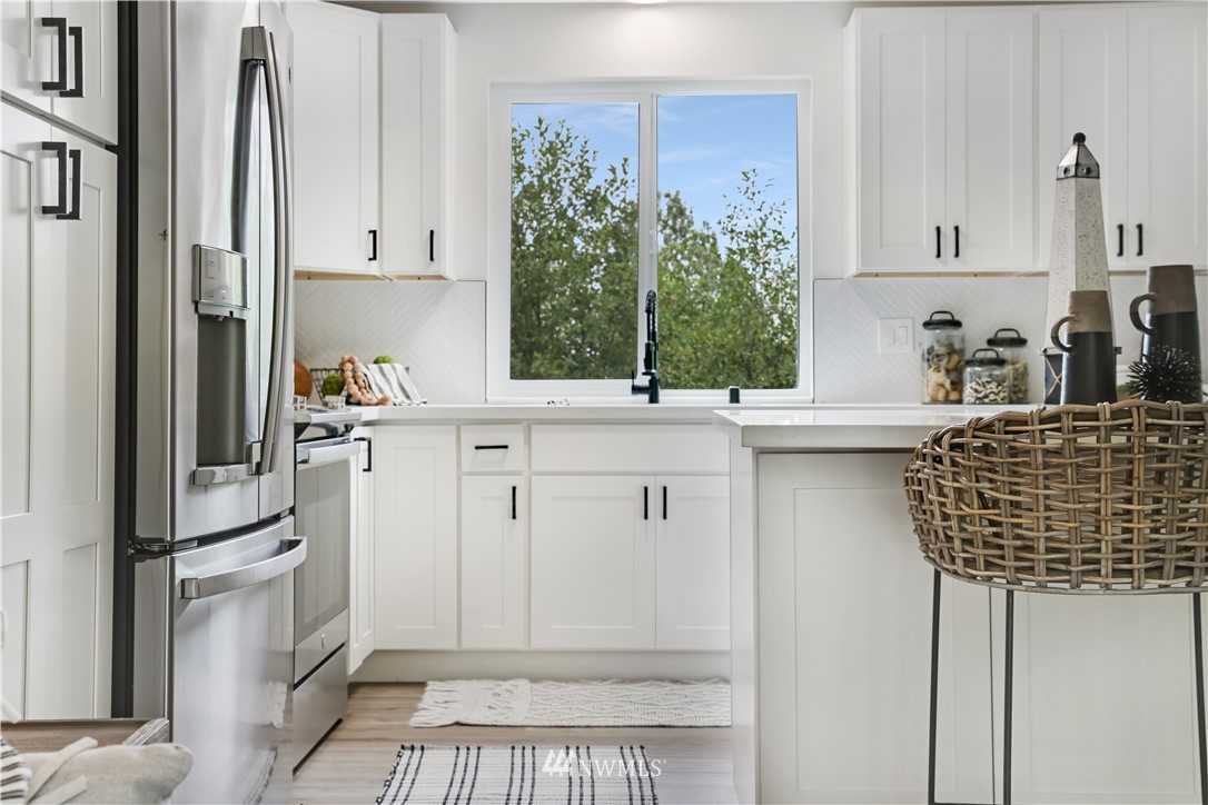 2807 Mill Avenue South Renton, WA 98055 - Photo 7 of 34 a kitchen with white cabinets and sink