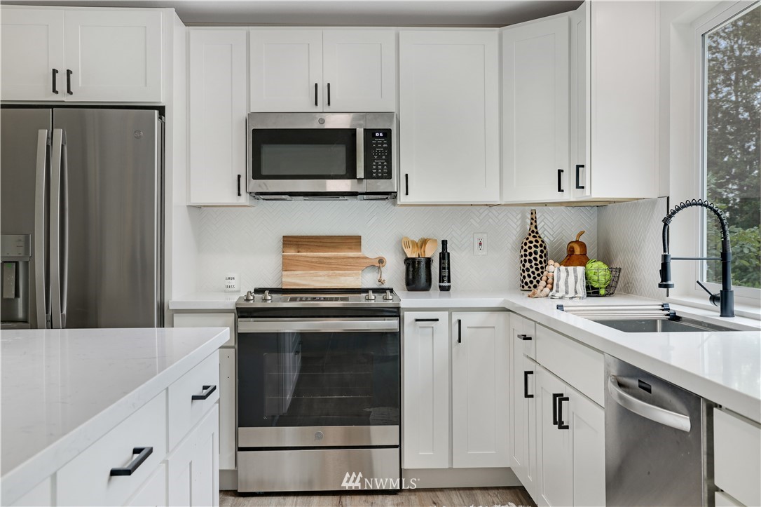 2807 Mill Avenue South Renton, WA 98055 - Photo 8 of 34 a kitchen with cabinets stainless steel appliances and sink