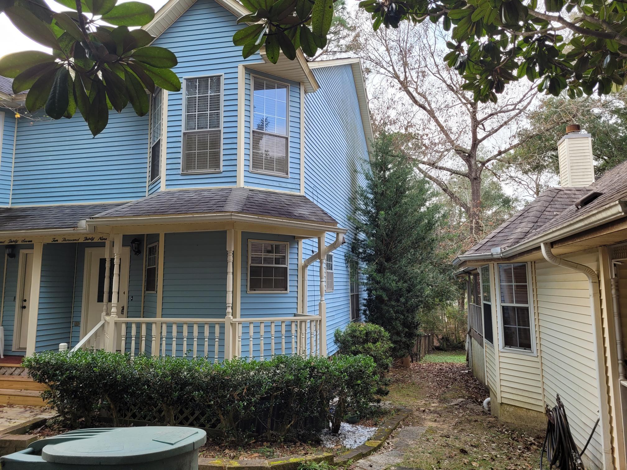 10039 Foxrun Road Pensacola, FL 32514 - Photo 1 of 9 a view of a house with a yard and potted plants
