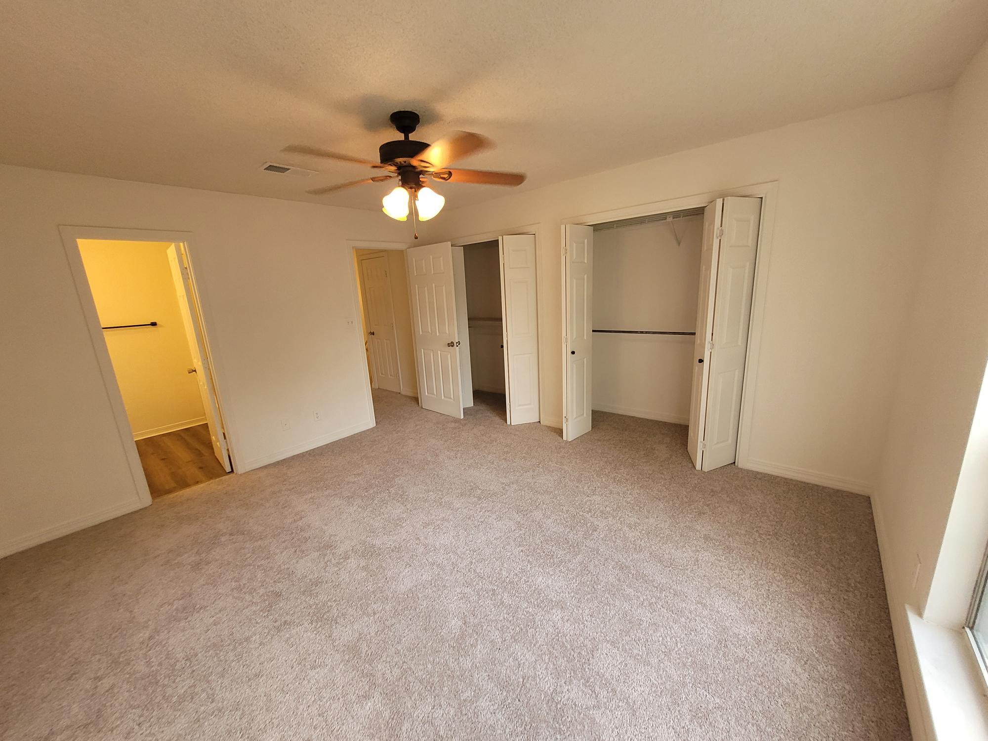 10039 Foxrun Road Pensacola, FL 32514 - Photo 2 of 9 a view of a big room with closet and a chandelier fan