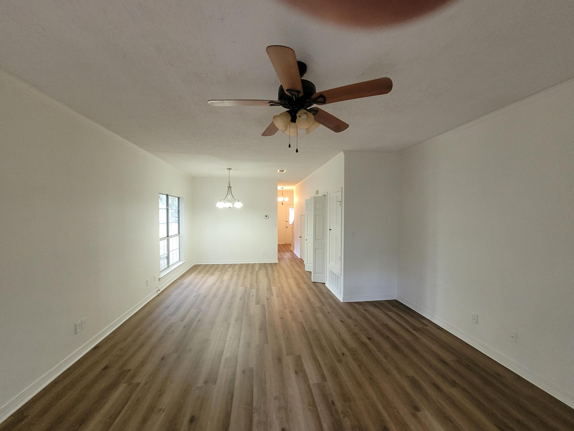 10039 Foxrun Road Pensacola, FL 32514 - Photo 7 of 9 a view of empty room with wooden floor and fan