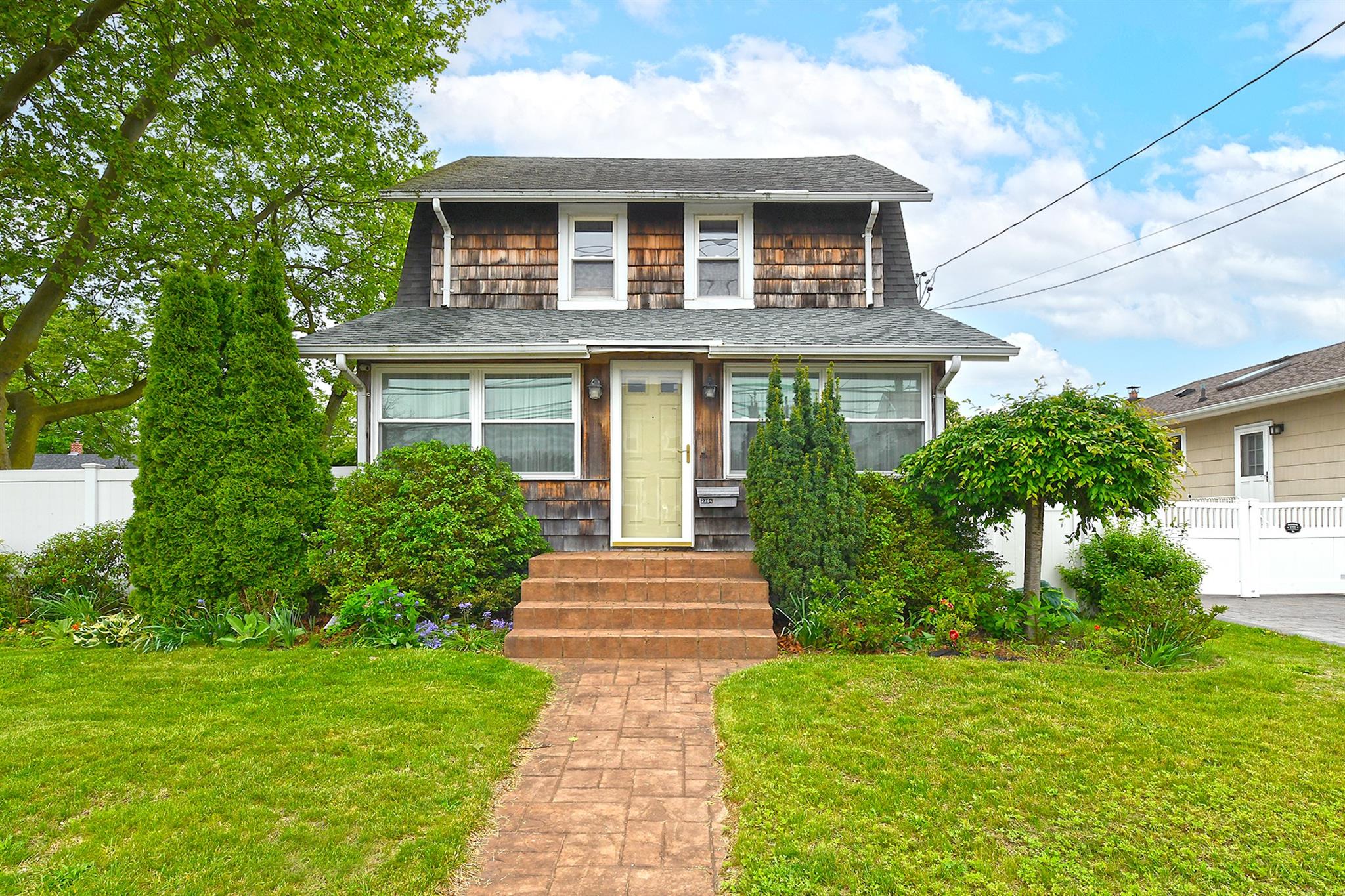 2364 Newbridge Road Bellmore, NY 11710 - Photo 1 of 1 a front view of a house with a yard