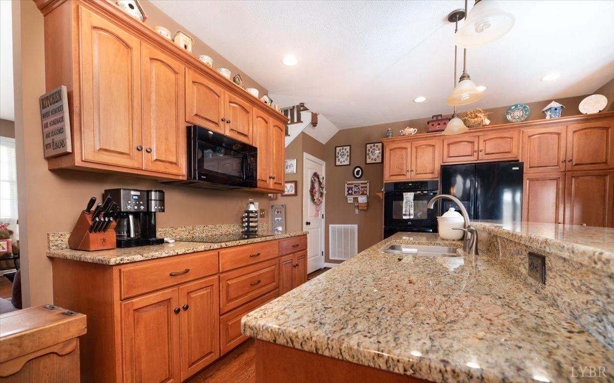 1158 Lowesville Road Amherst, VA 24521 - Photo 13 of 48 a kitchen with stainless steel appliances granite countertop a sink a stove and a microwave