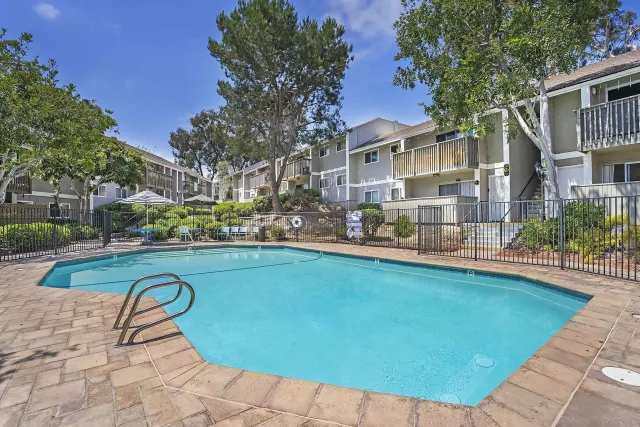 a view of swimming pool with outdoor seating and plants