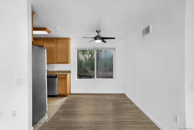 a view of an empty room with a fireplace and a window